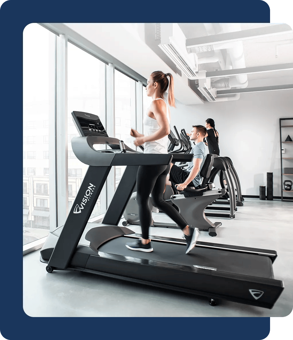 Group training on Vision Fitness cardio equipment in a bright facility
