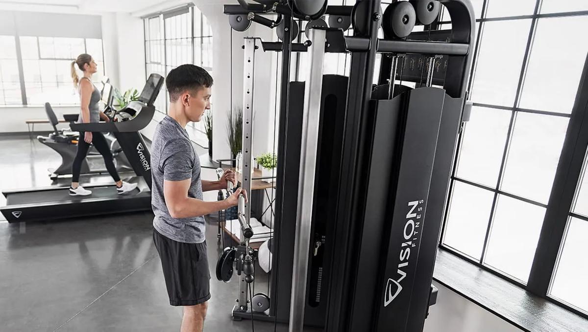 Person performing cable curls on a Vision Fitness functional trainer